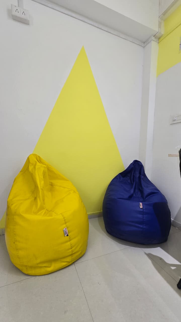 Bean bag corner with yellow triangle wall art